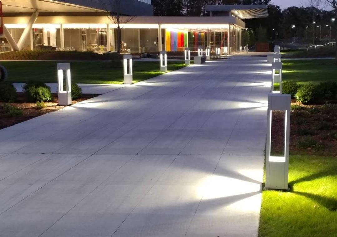 Anti-glare bollard lights installed along a contemporary public pedestrian pathway.