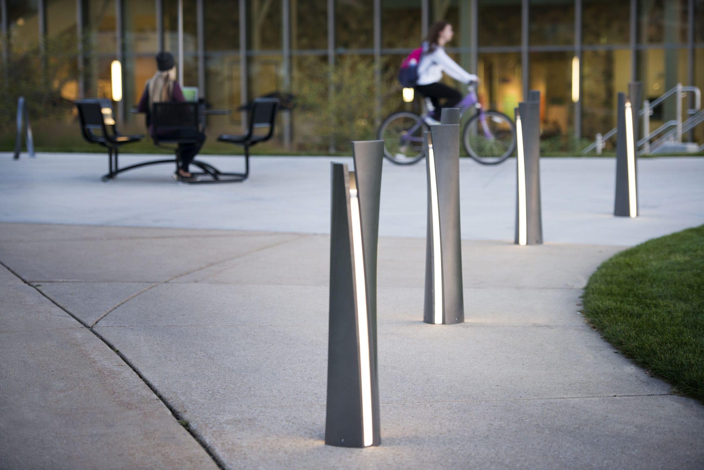 Anti-glare bollard lights installed along a contemporary public pedestrian pathway.