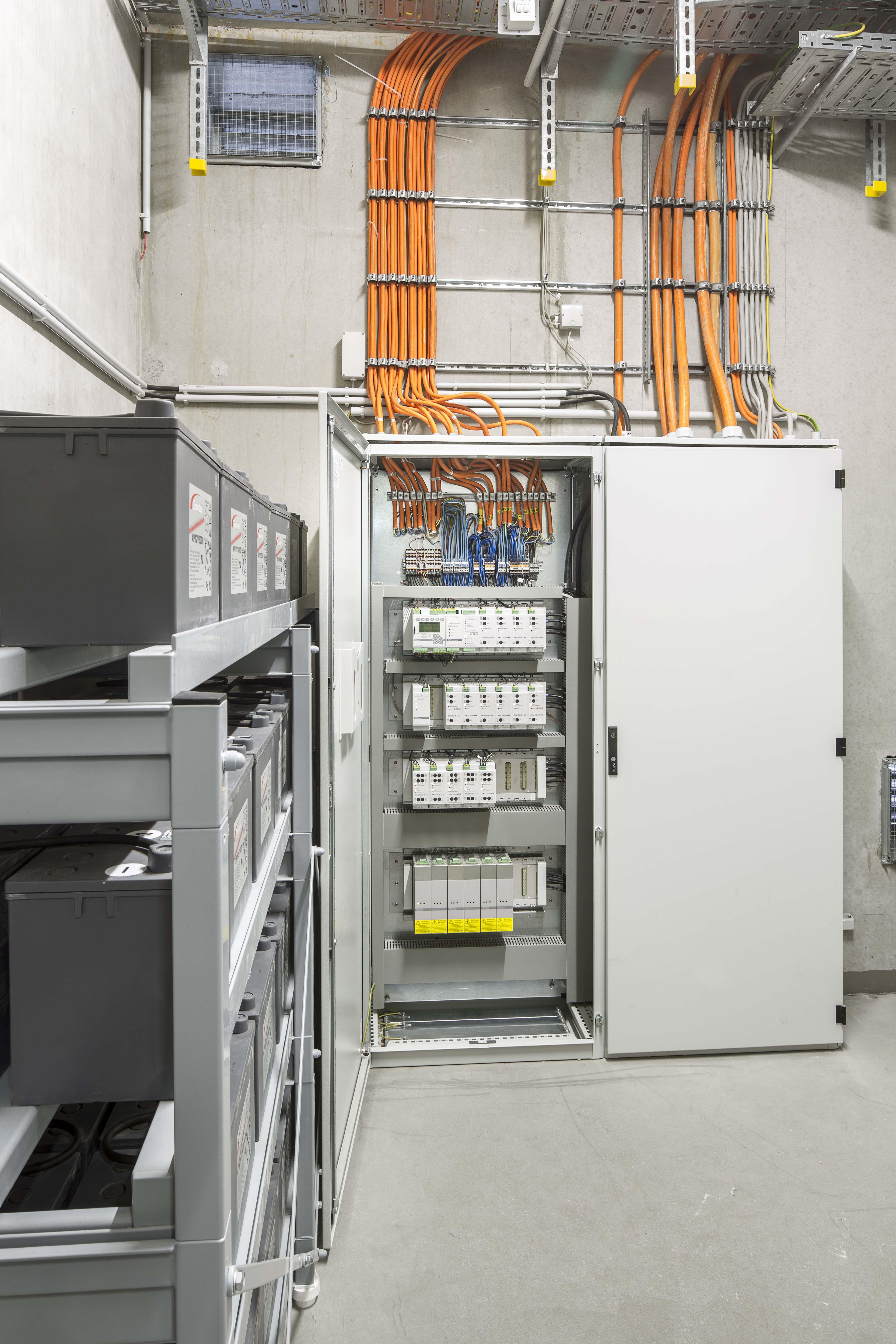 Central battery emergency lights installed in a contemporary infrastructure environment.