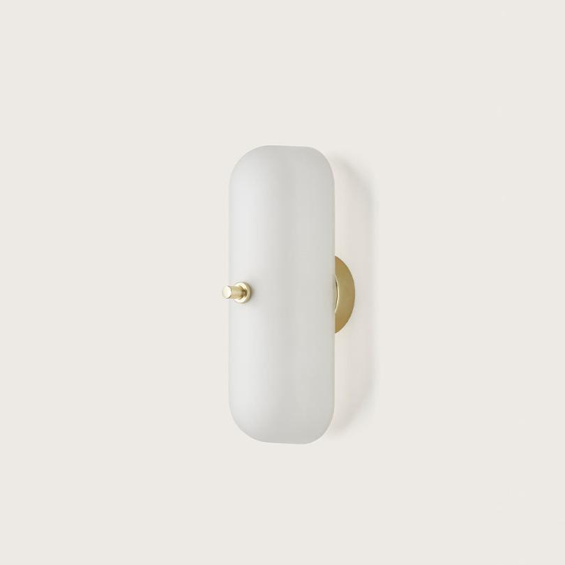 Front view of a bedside wall lamp with integrated reading light and refined finish.