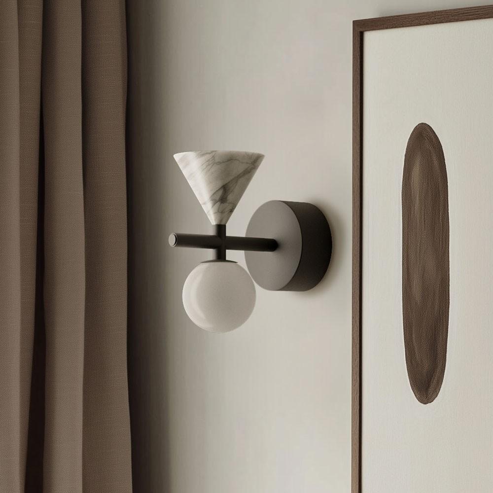 Bedside wall lamp installed beside a luxury hotel bed providing warm ambient illumination.