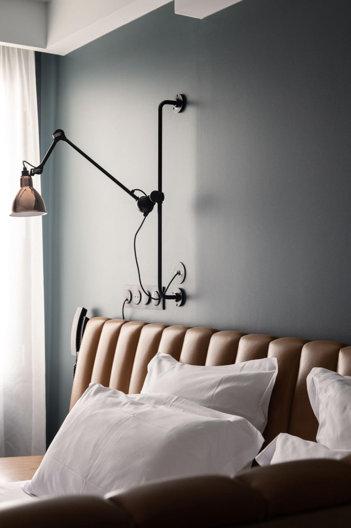 Industrial wall lamp installed in a contemporary restaurant with industrial architectural styling.