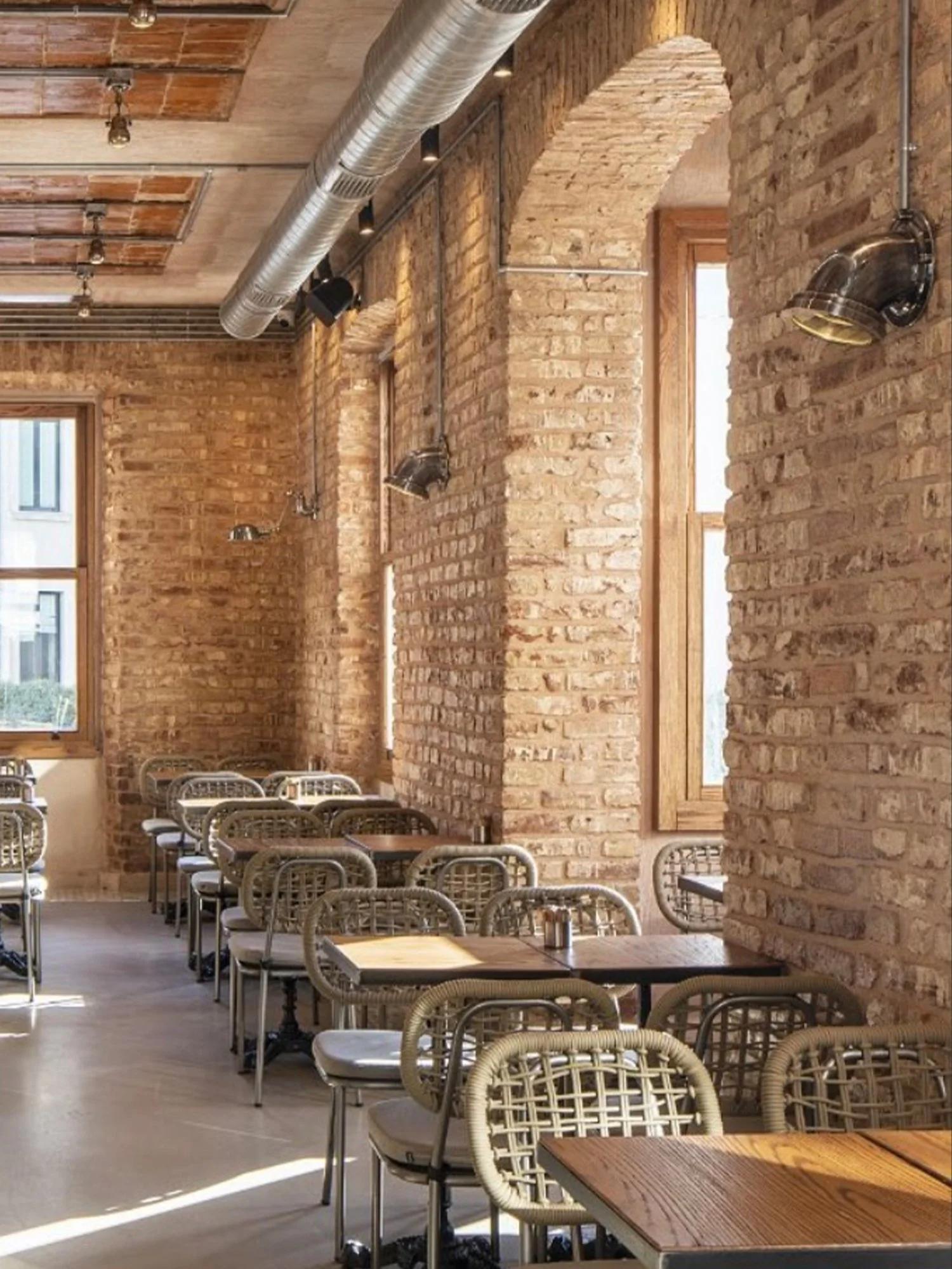 Industrial wall lamp installed in a contemporary restaurant with industrial architectural styling.