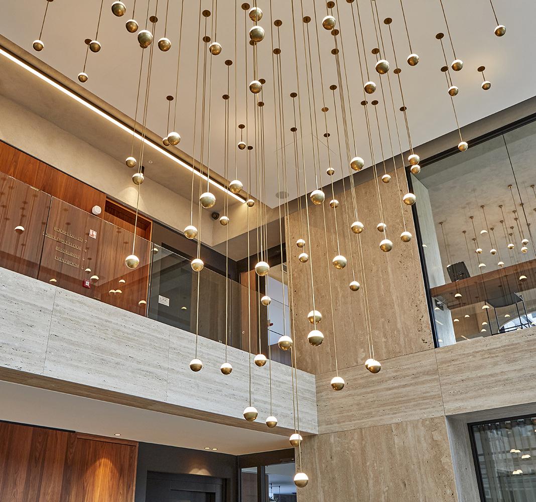 Cluster pendant lighting installed in a luxury hospitality interior.