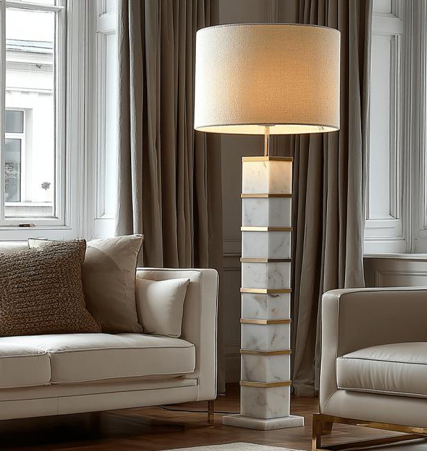 Marble floor lamp positioned beside a seating area in a luxury hotel lounge creating warm ambient lighting and timeless architectural elegance.