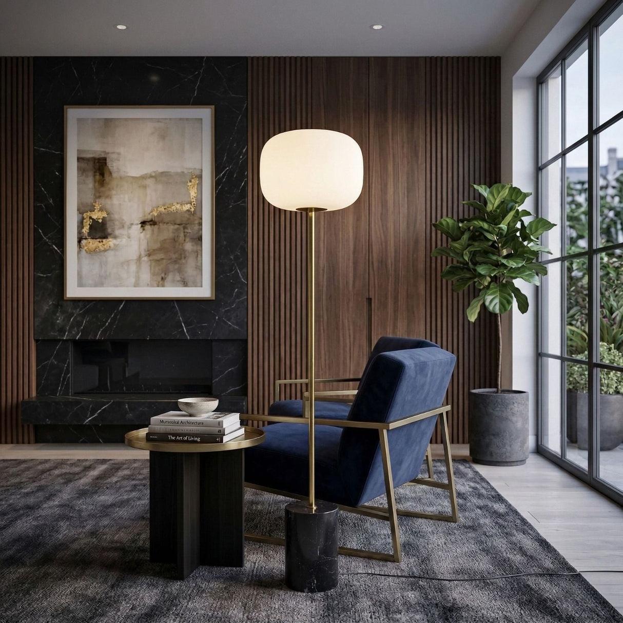 Marble floor lamp positioned beside a seating area in a luxury hotel lounge creating warm ambient lighting and timeless architectural elegance.