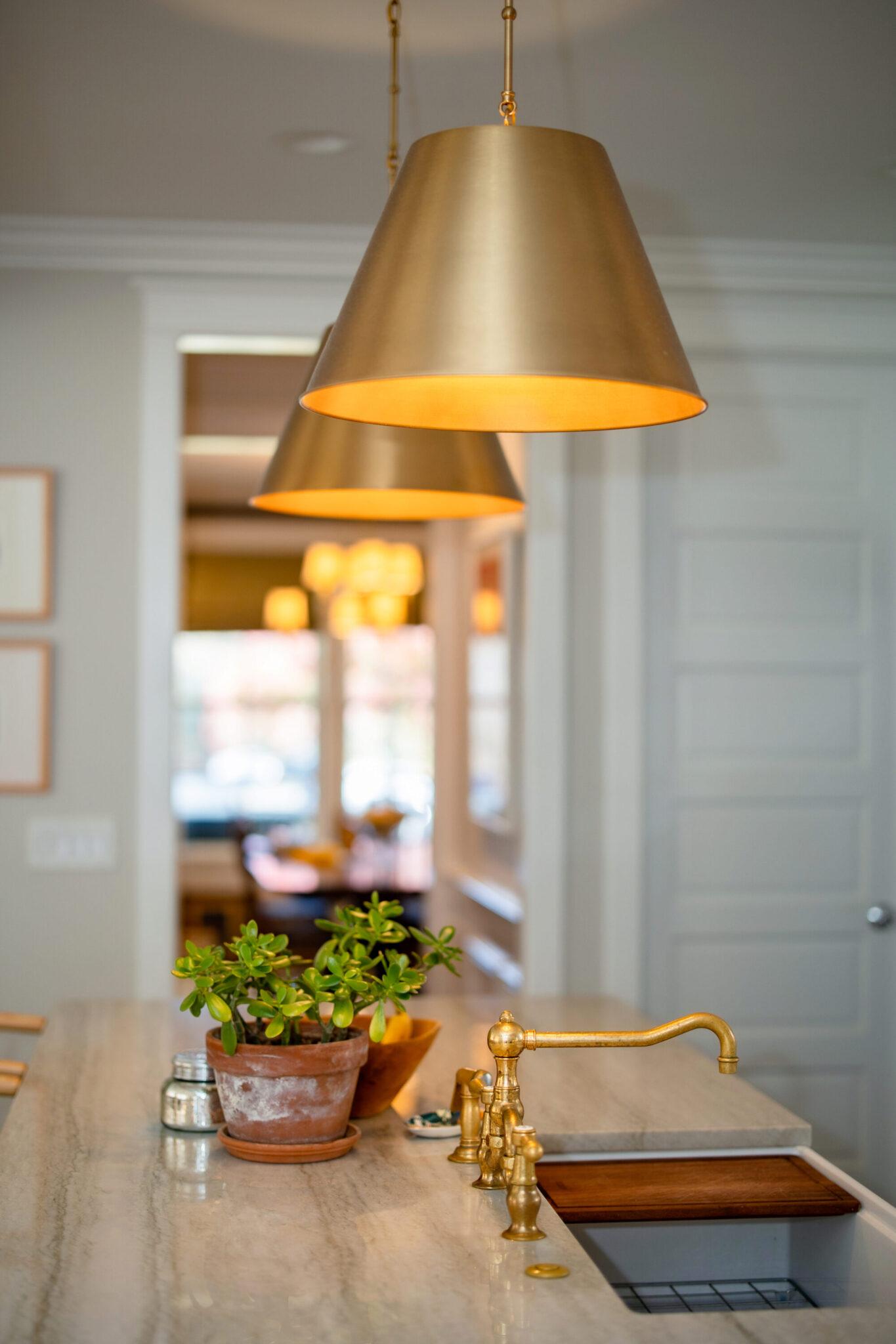 Brass pendant lighting installed in a luxury hospitality interior.