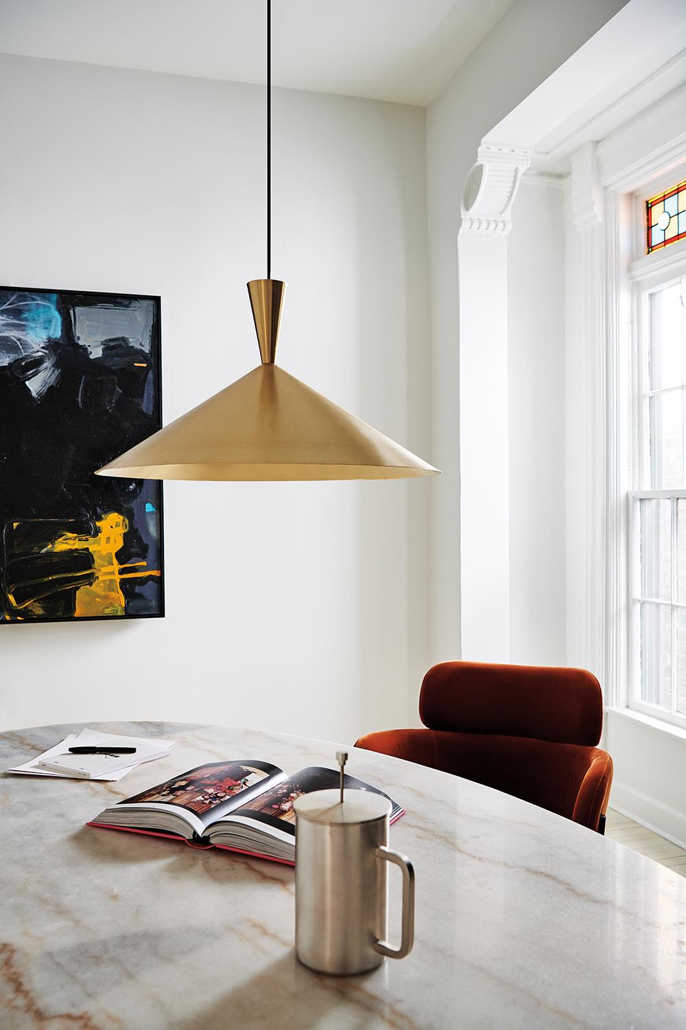 Brass pendant lighting installed in a luxury hospitality interior.