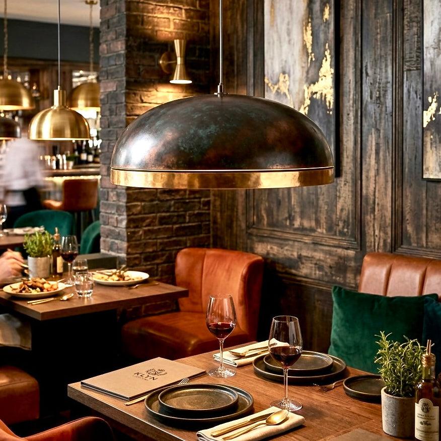 Brass pendant lighting installed in a luxury hospitality interior.