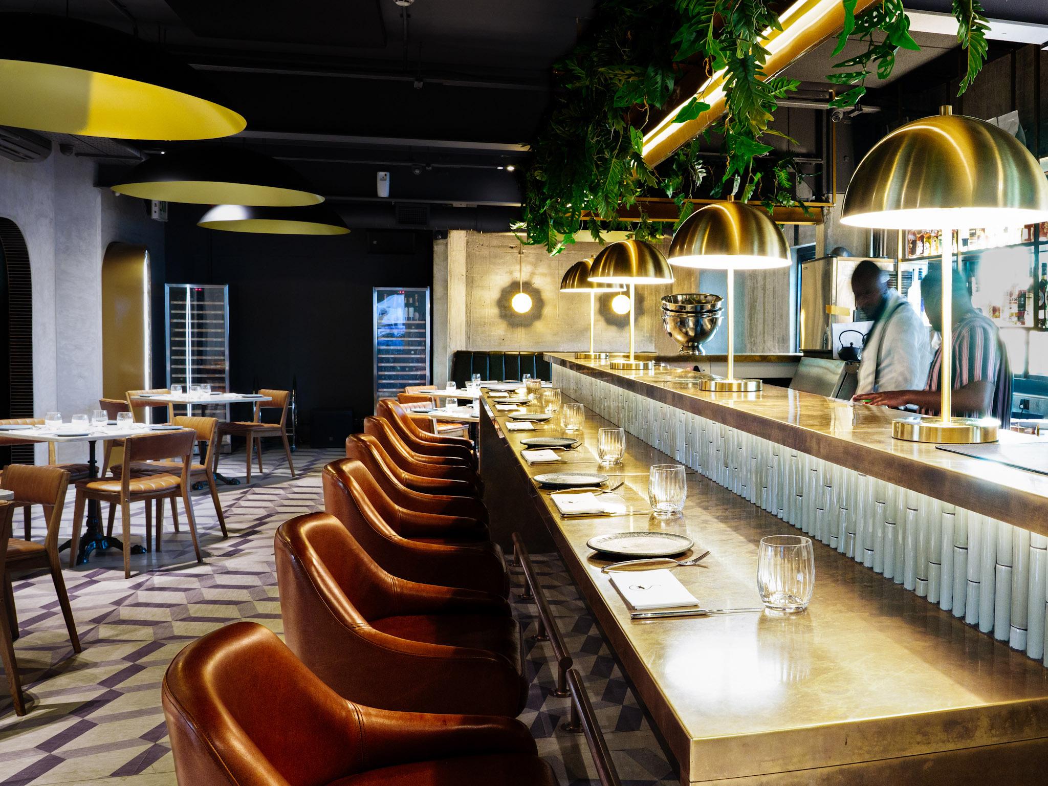 Brass pendant lighting installed in a luxury hospitality interior.
