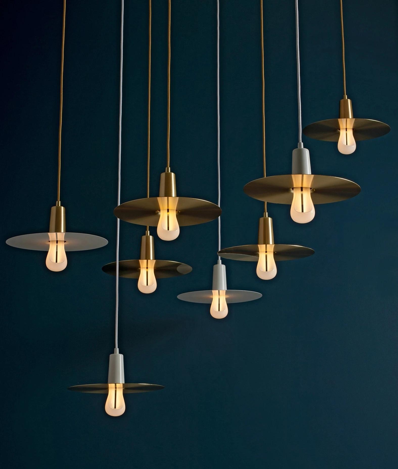 Brass pendant lighting family featuring multiple sizes and design variations.