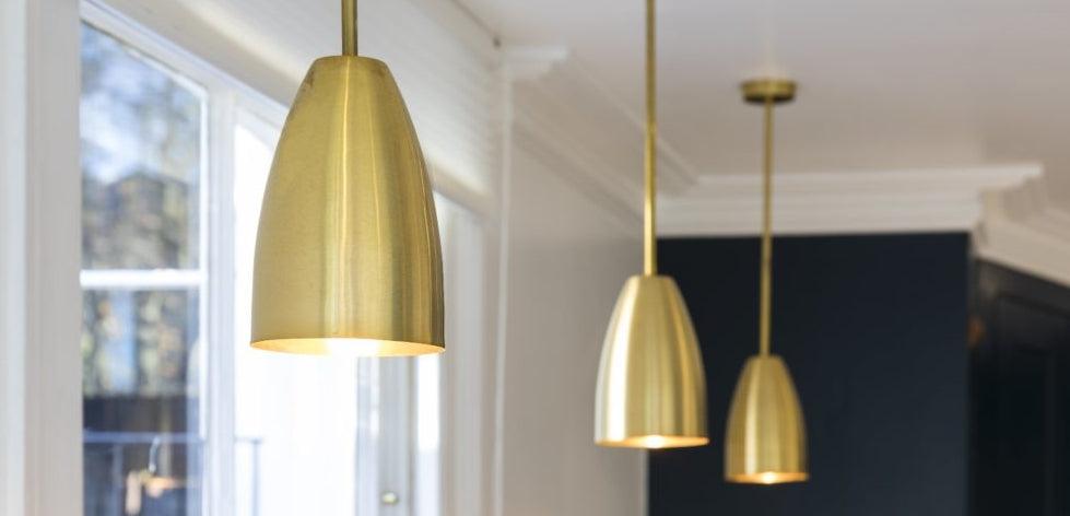 Brass pendant lighting installed in a luxury hospitality interior.