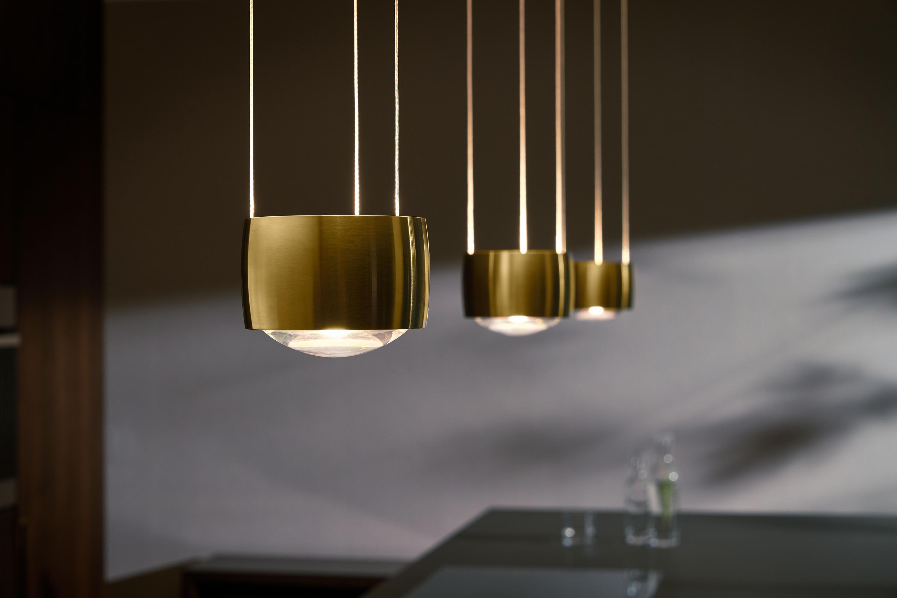 Brass pendant lighting installed in a luxury hospitality interior.