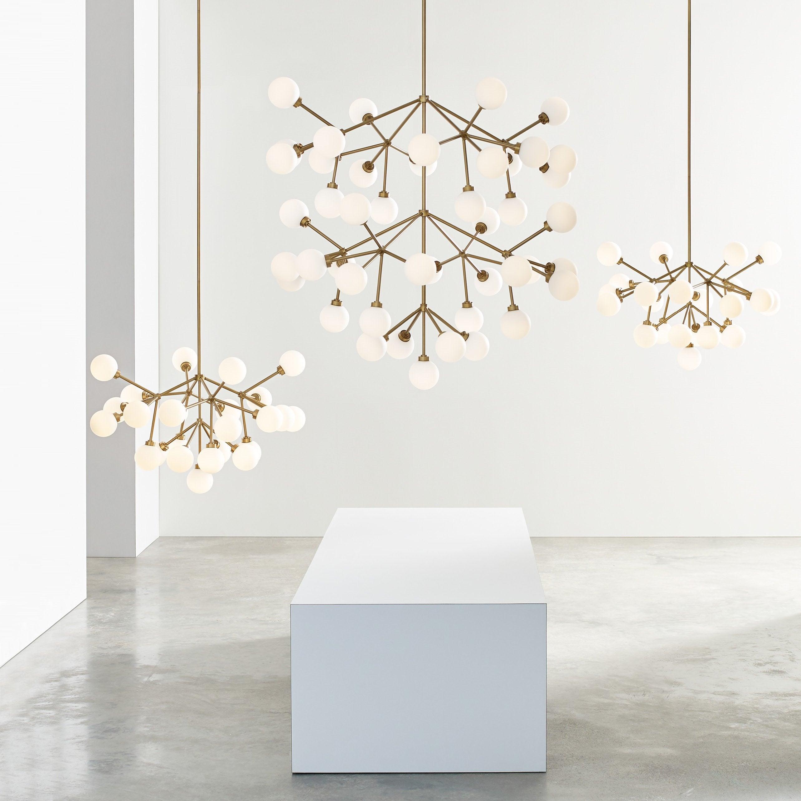 Globe chandelier family displaying linear, radial and molecular-inspired configurations.