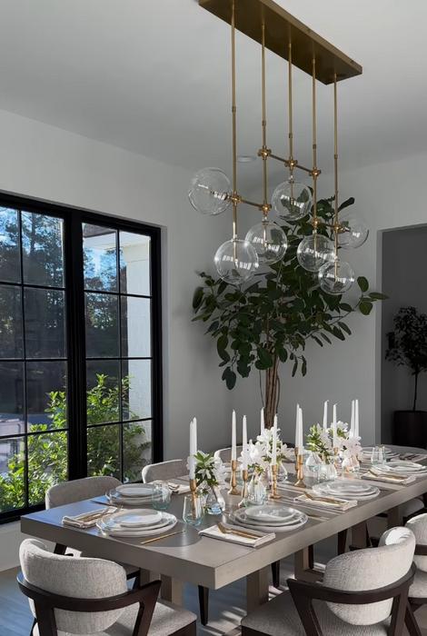 Globe chandelier installed in a premium residential dining area with contemporary architectural design.