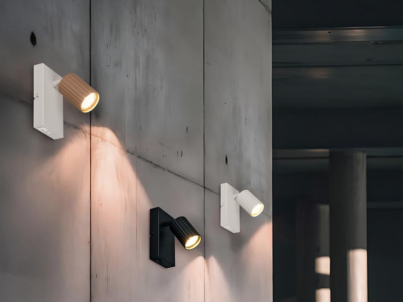 Interior wall-mounted spotlights installed in a contemporary hotel corridor.