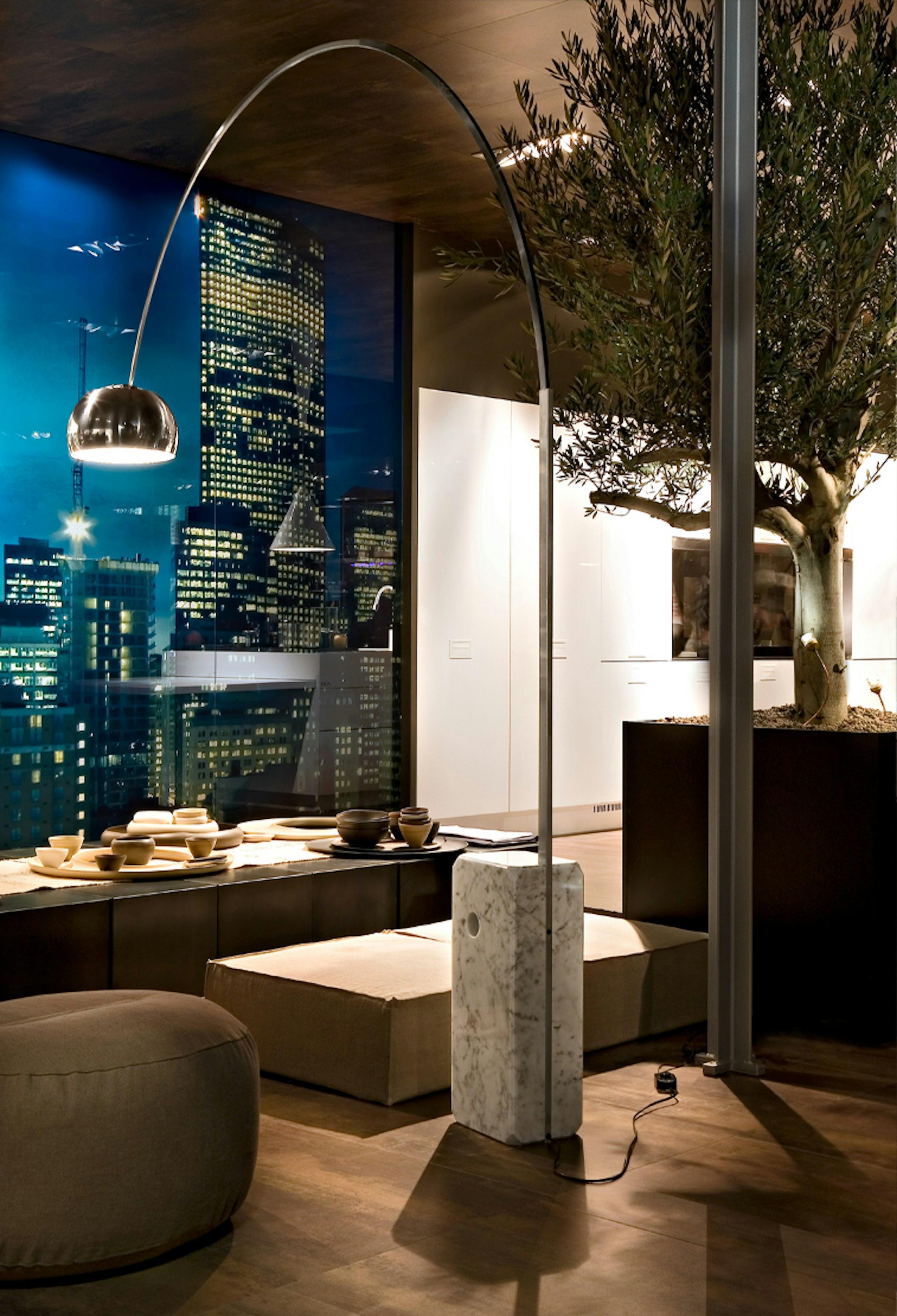 Arc floor lamp installed in a contemporary hospitality interior.