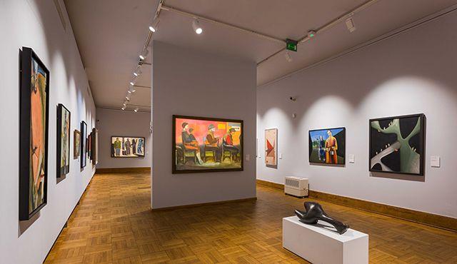 High CRI track spotlights illuminating artwork in a museum gallery.