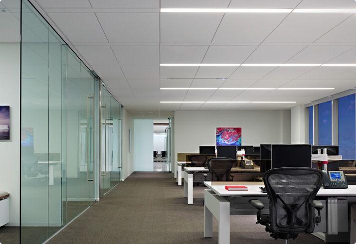 Recessed linear lights installed in a contemporary office environment.