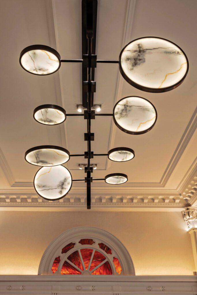 Marble ceiling lighting creating a refined decorative atmosphere in an elegant hospitality interior