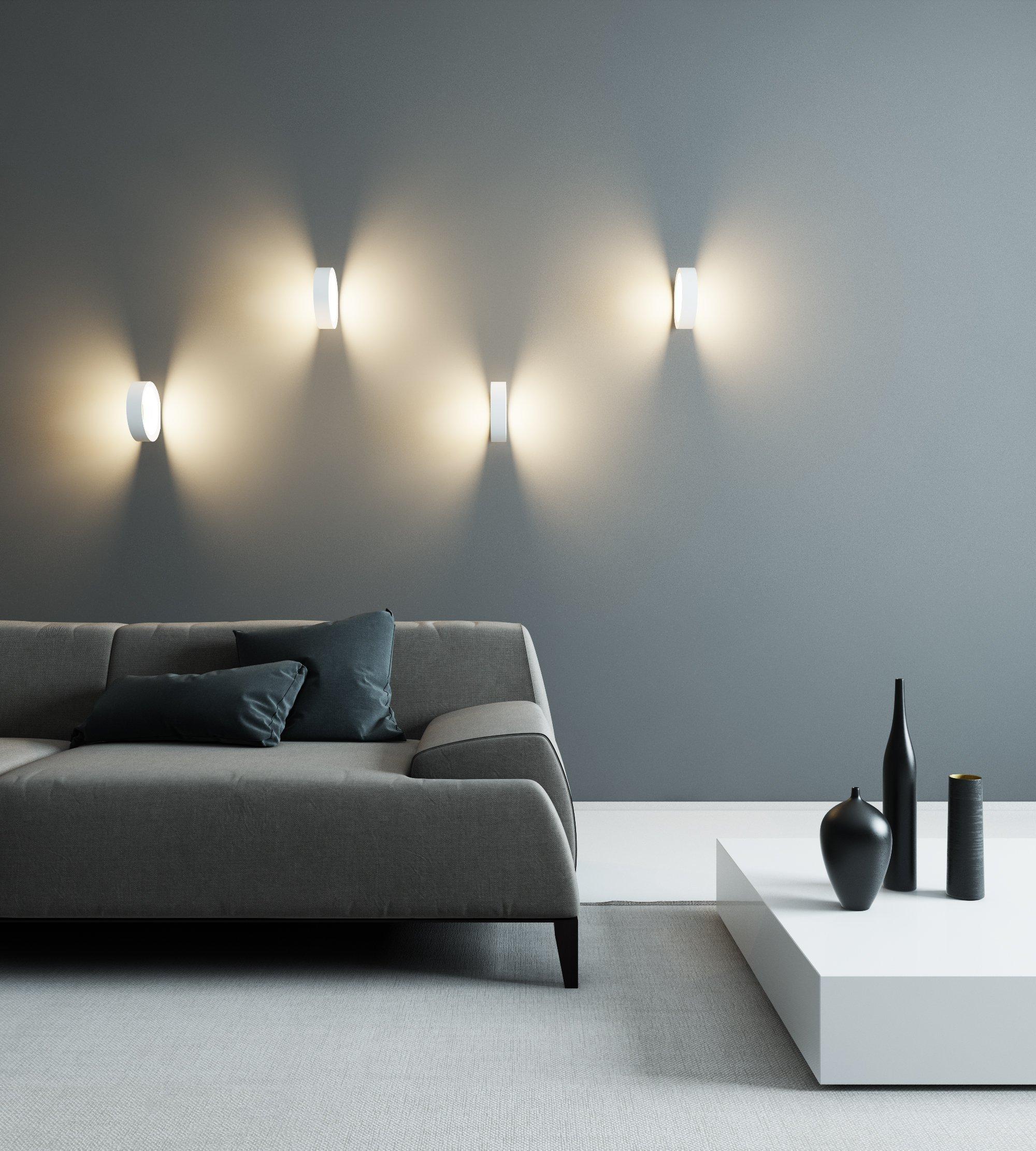 Minimal wall lamp installed in a contemporary hospitality interior.