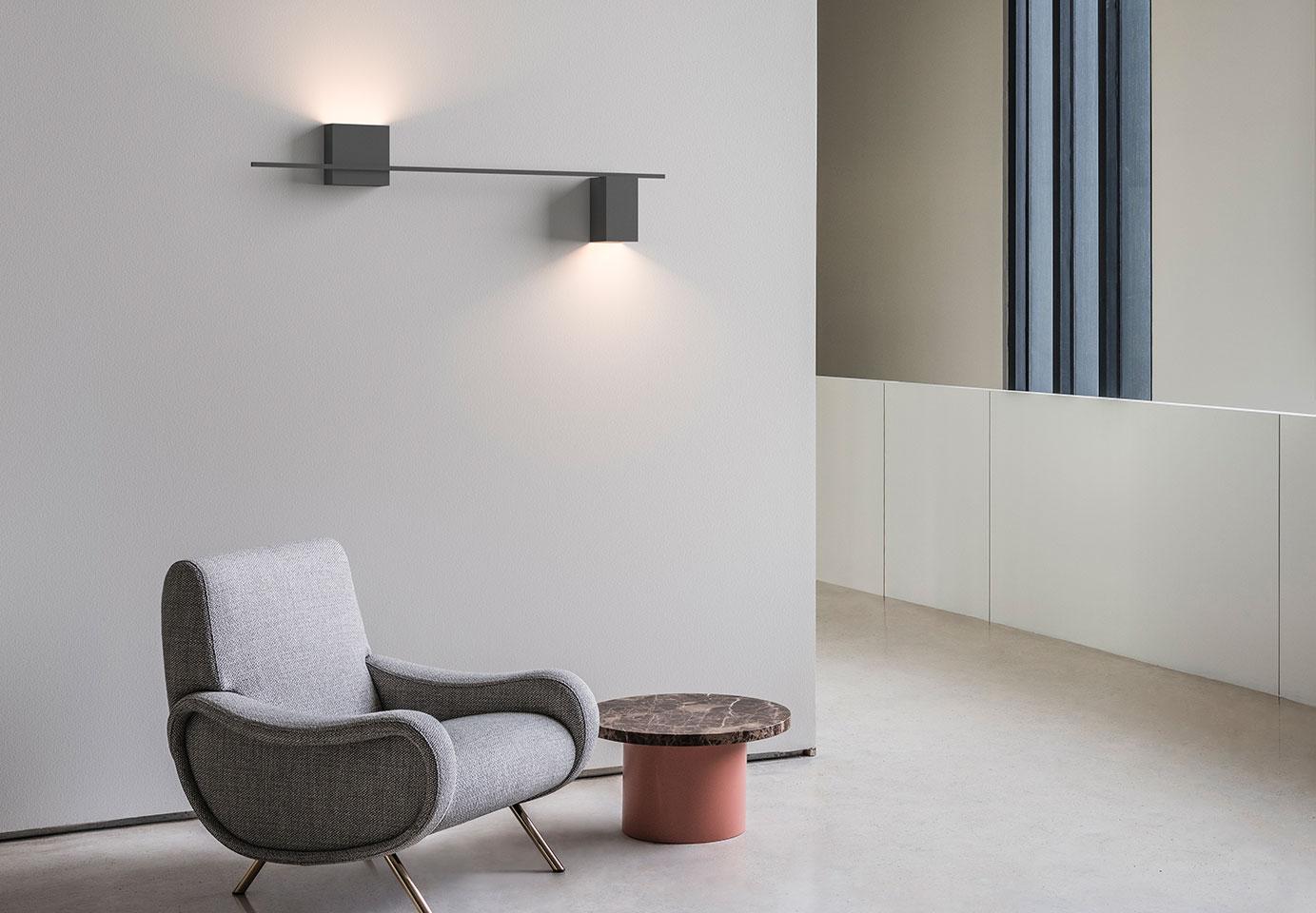 Minimal wall lamp installed in a contemporary hospitality interior.