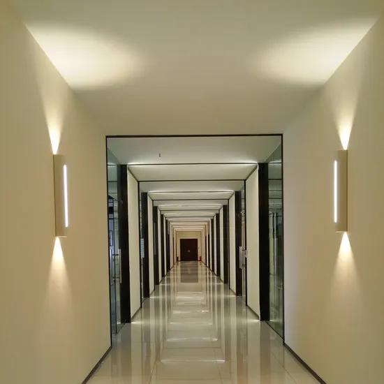 Minimal wall lamp installed in a contemporary hospitality interior.
