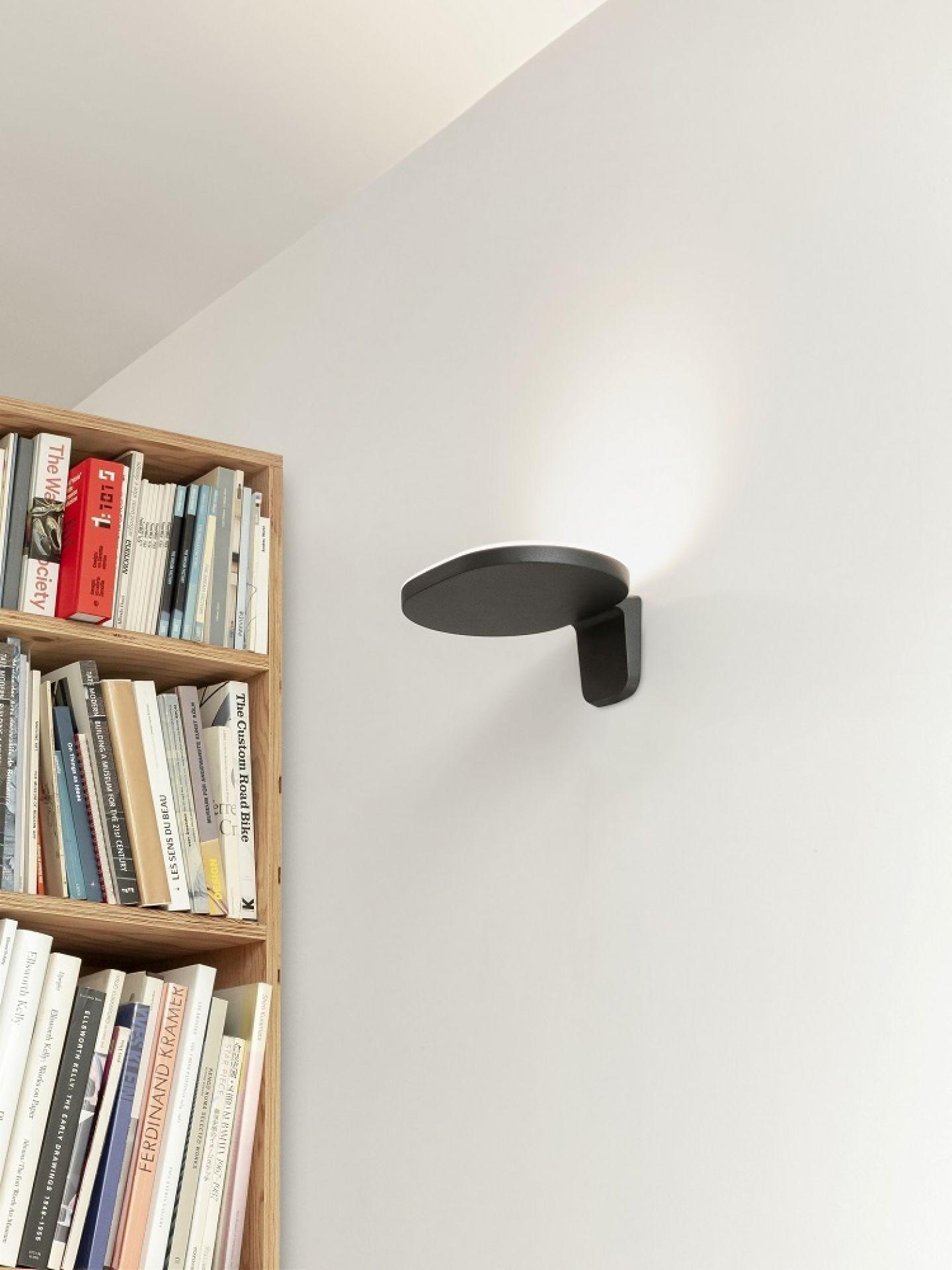 Minimal wall lamp installed in a contemporary hospitality interior.