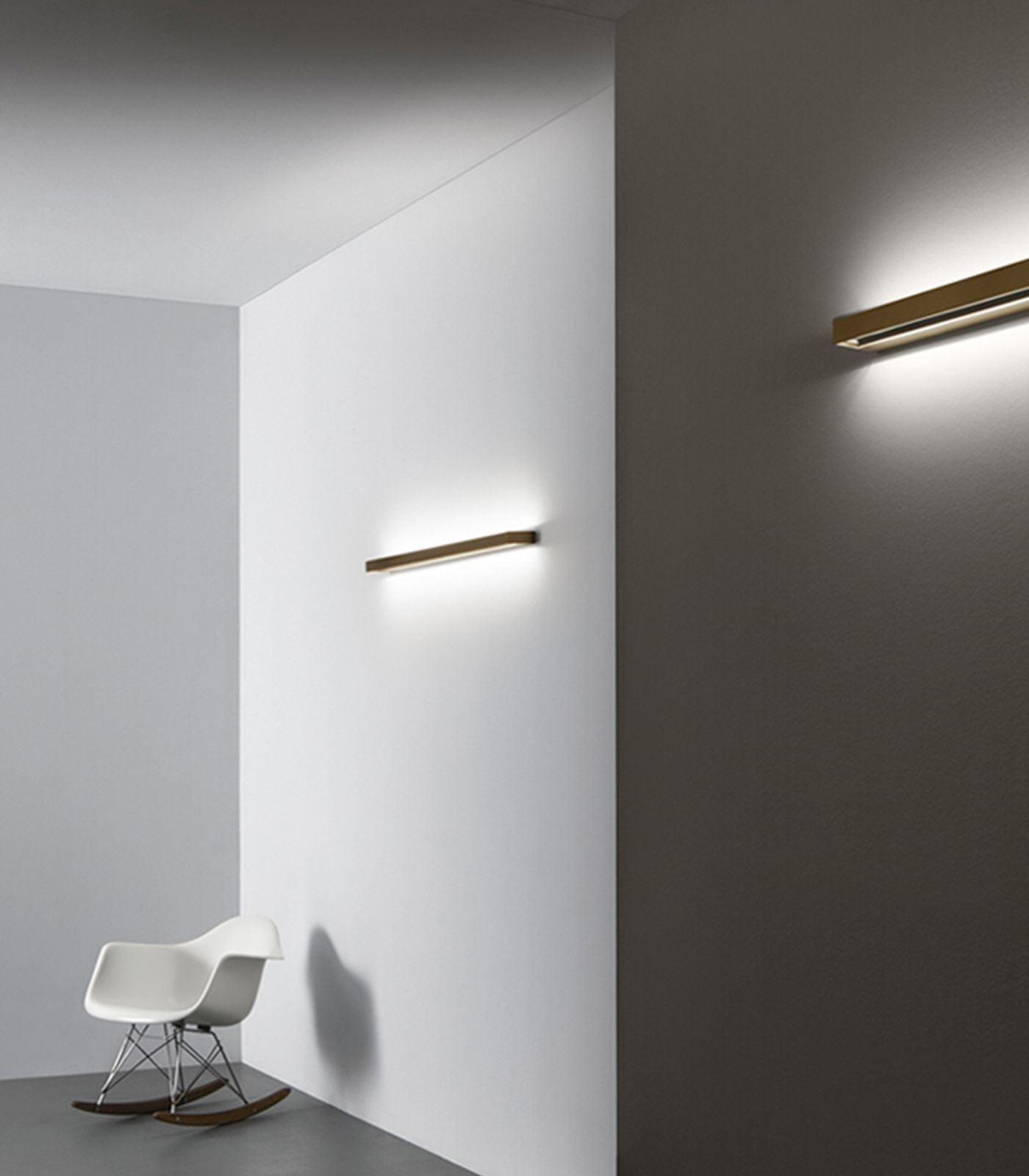 Minimal wall lamp installed in a contemporary hospitality interior.