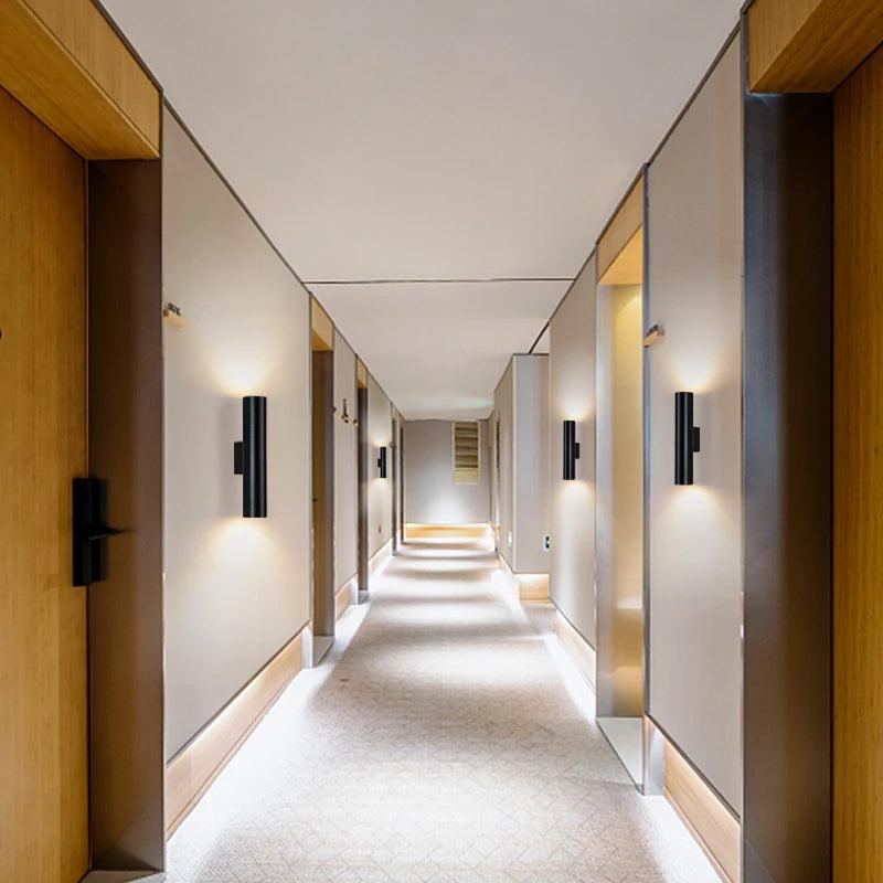 Minimal wall lamp installed in a contemporary hospitality interior.