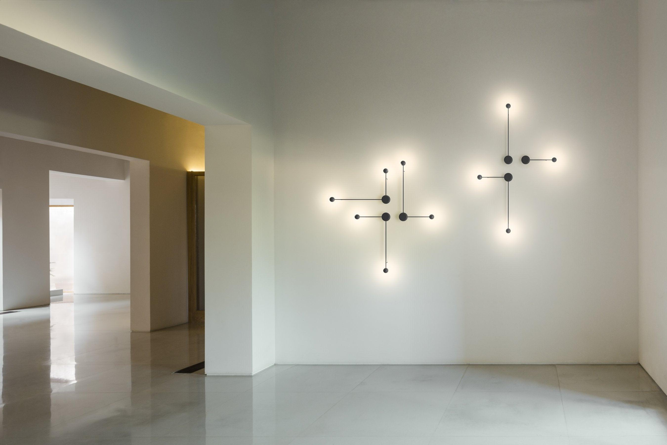 Minimal wall lamp installed in a contemporary hospitality interior.