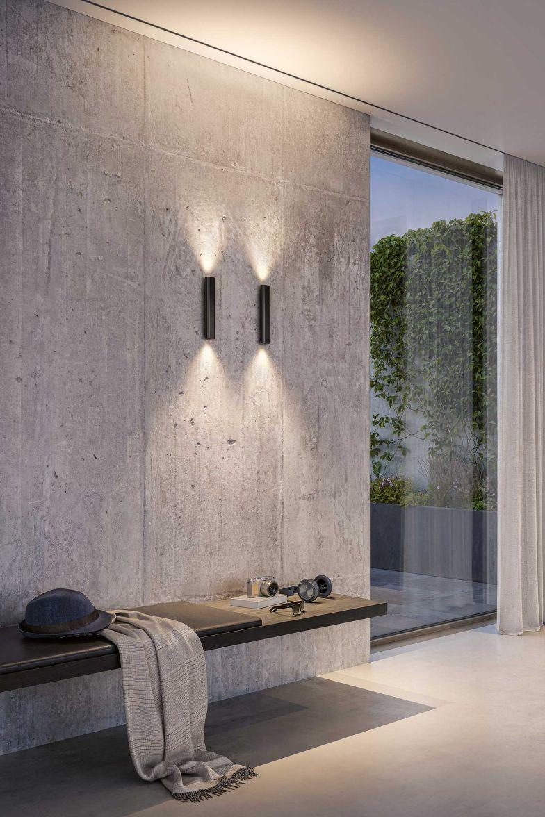 Minimal wall lamp installed in a contemporary hospitality interior.