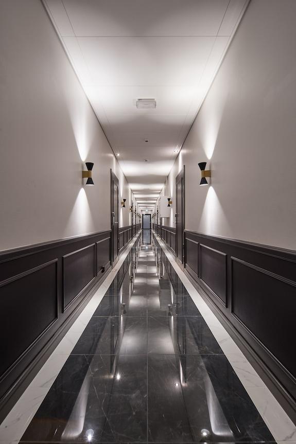 Minimal wall lamp installed in a contemporary hospitality interior.