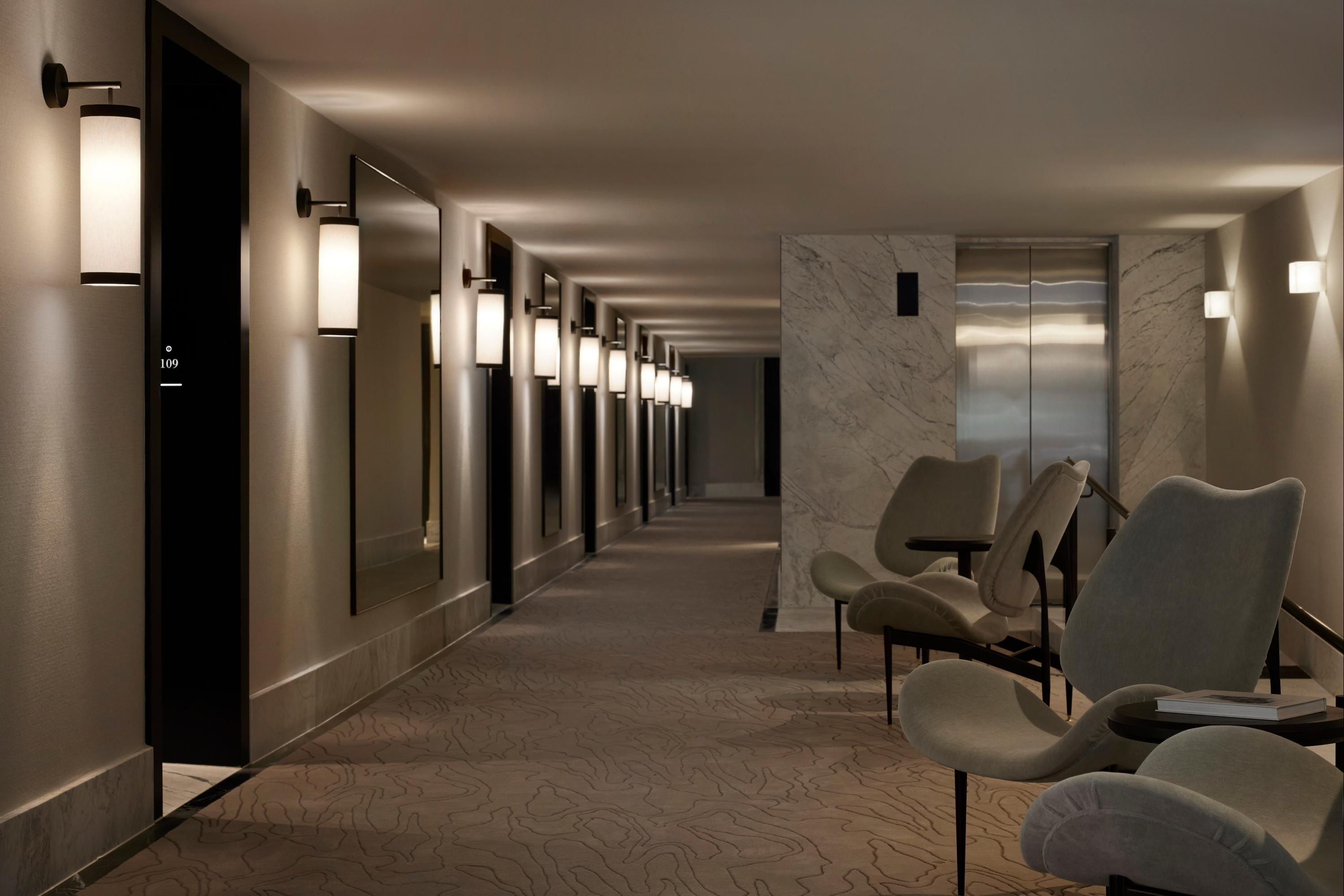 Minimal wall lamp installed in a contemporary hospitality interior.