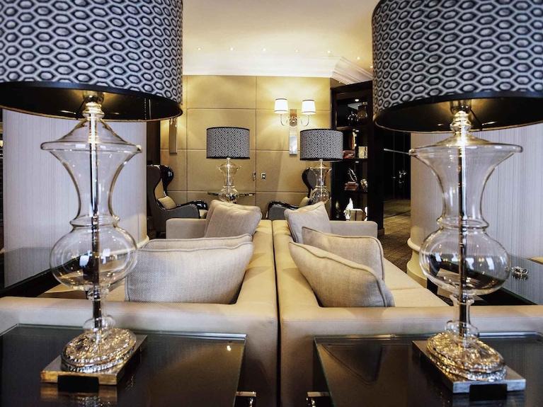 Crystal table lamp displayed in a luxury hotel lobby creating sparkling reflections and sophisticated ambient lighting.