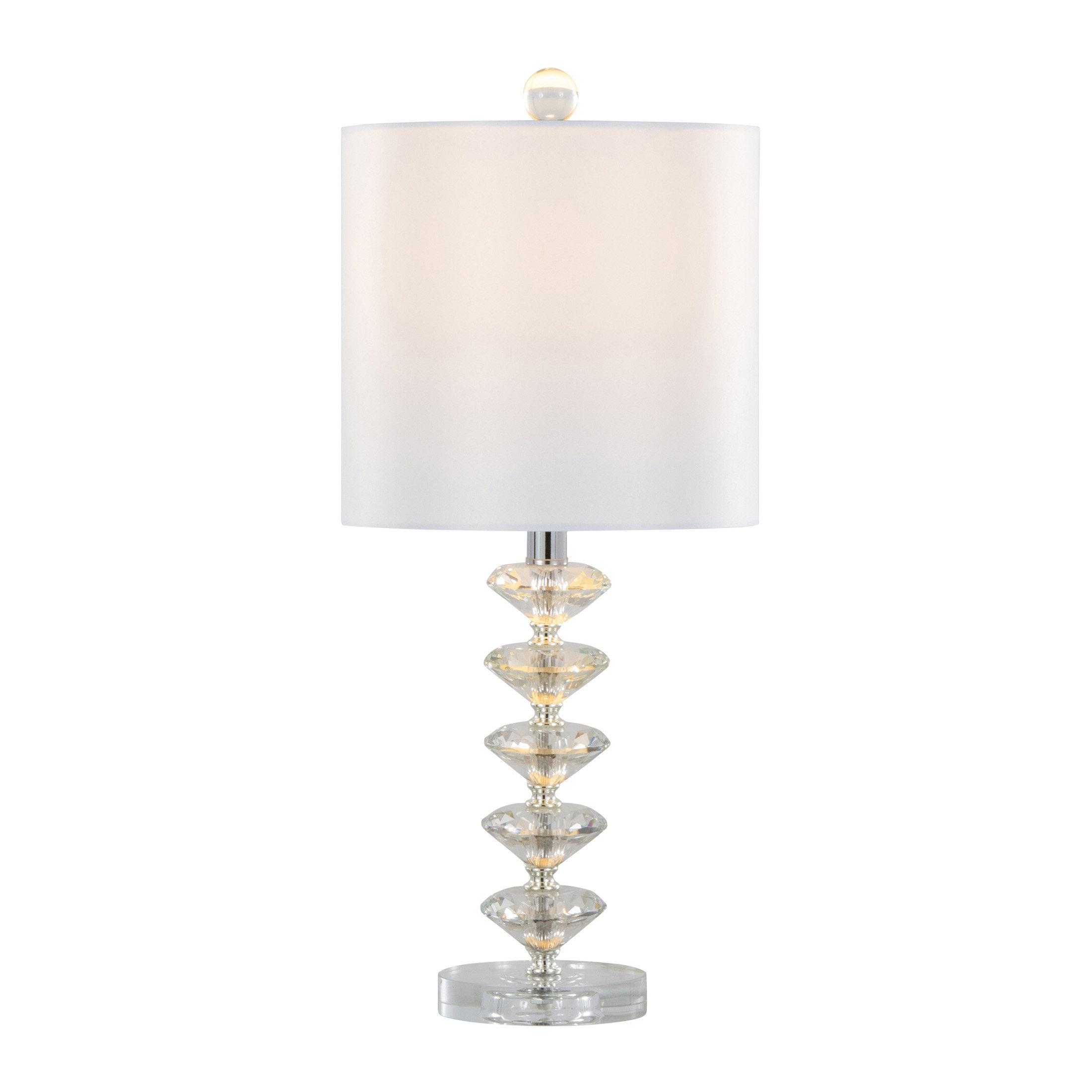 Crystal table lamp photographed on a clean white background showcasing precision-cut crystal elements and premium metal finishes.