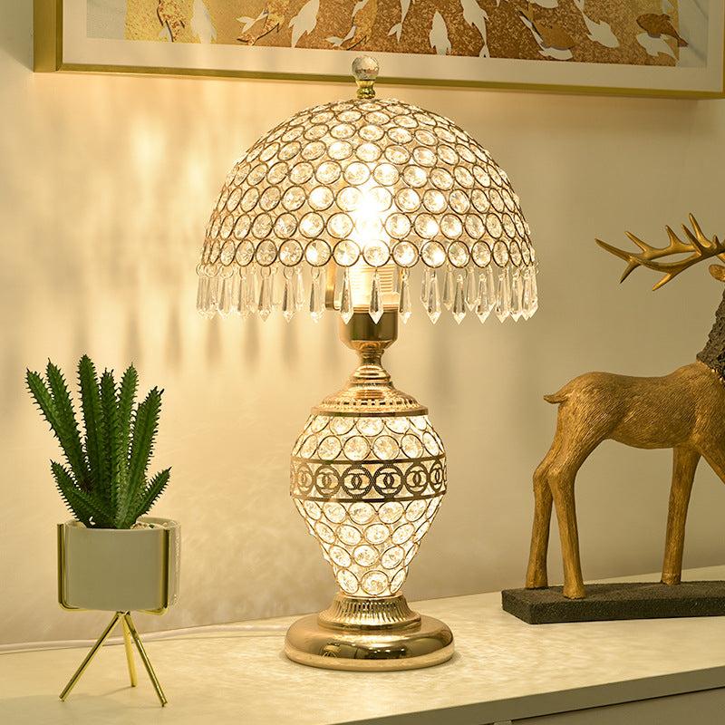 Crystal table lamp displayed in a luxury hotel lobby creating sparkling reflections and sophisticated ambient lighting.