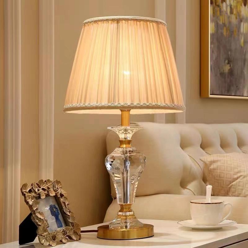 Crystal table lamp displayed in a luxury hotel lobby creating sparkling reflections and sophisticated ambient lighting.