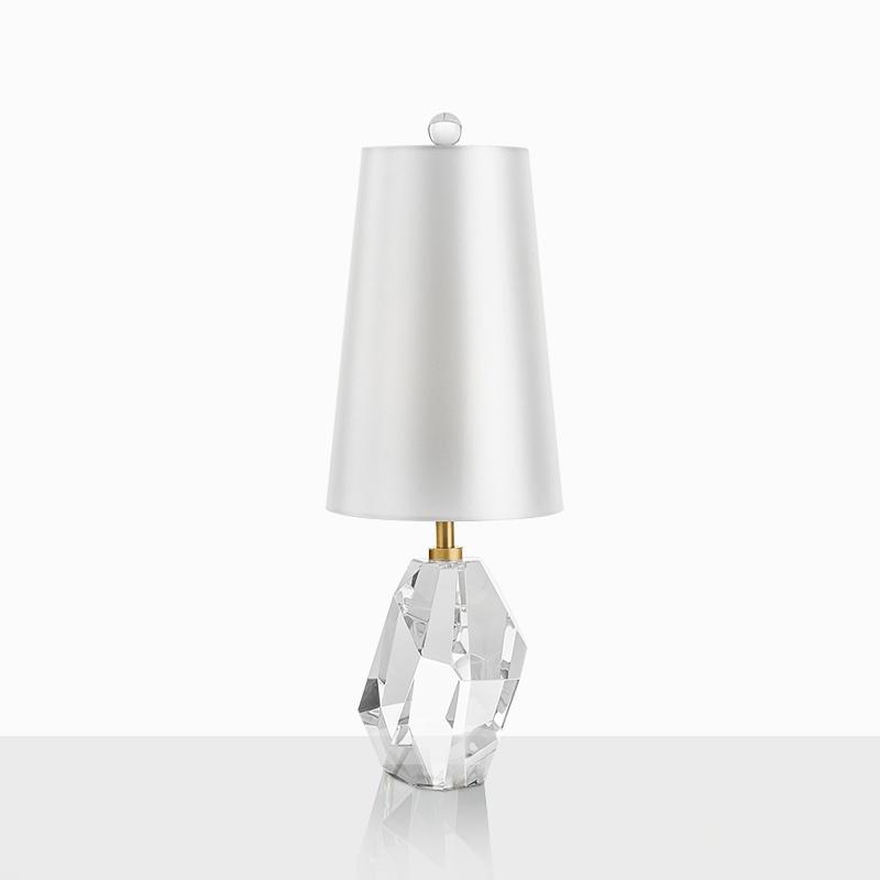 Crystal table lamp photographed on a clean white background showcasing precision-cut crystal elements and premium metal finishes.