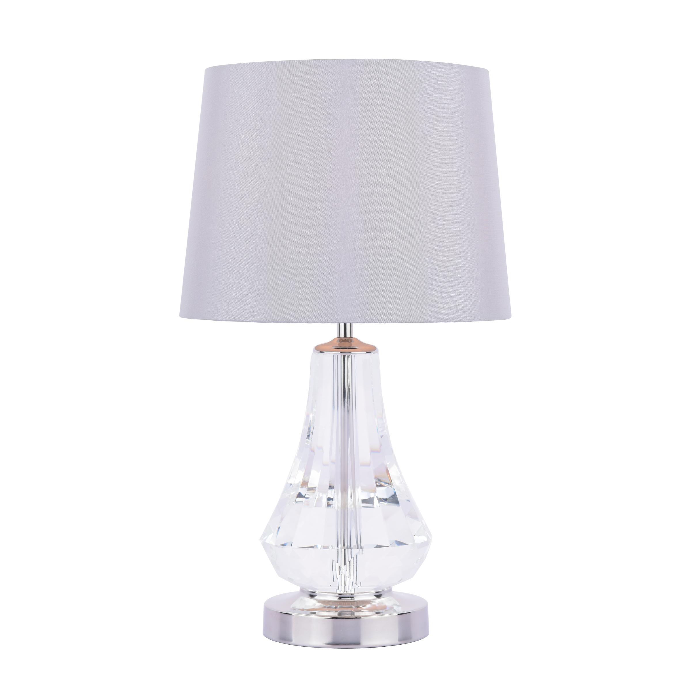 Crystal table lamp photographed on a clean white background showcasing precision-cut crystal elements and premium metal finishes.