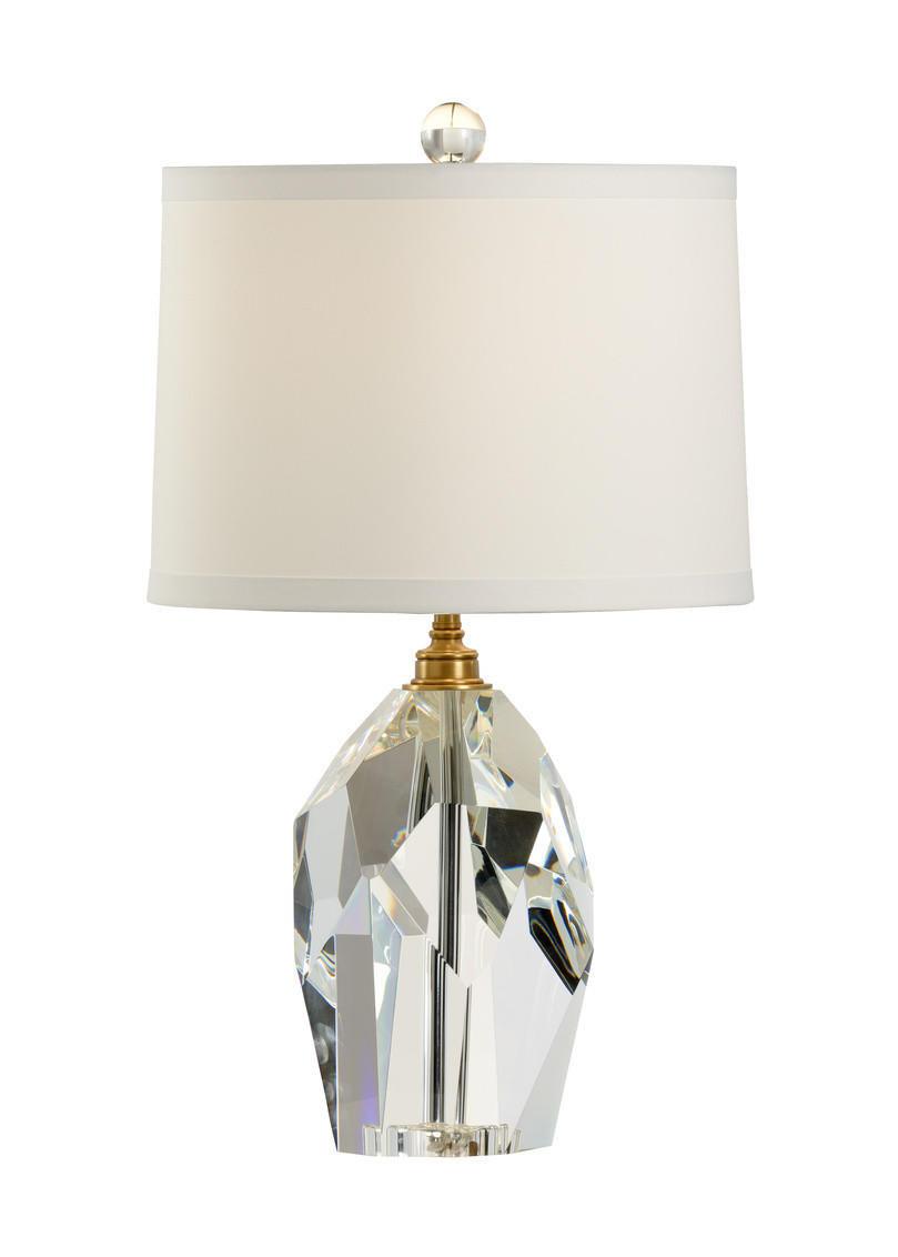 Crystal table lamp photographed on a clean white background showcasing precision-cut crystal elements and premium metal finishes.