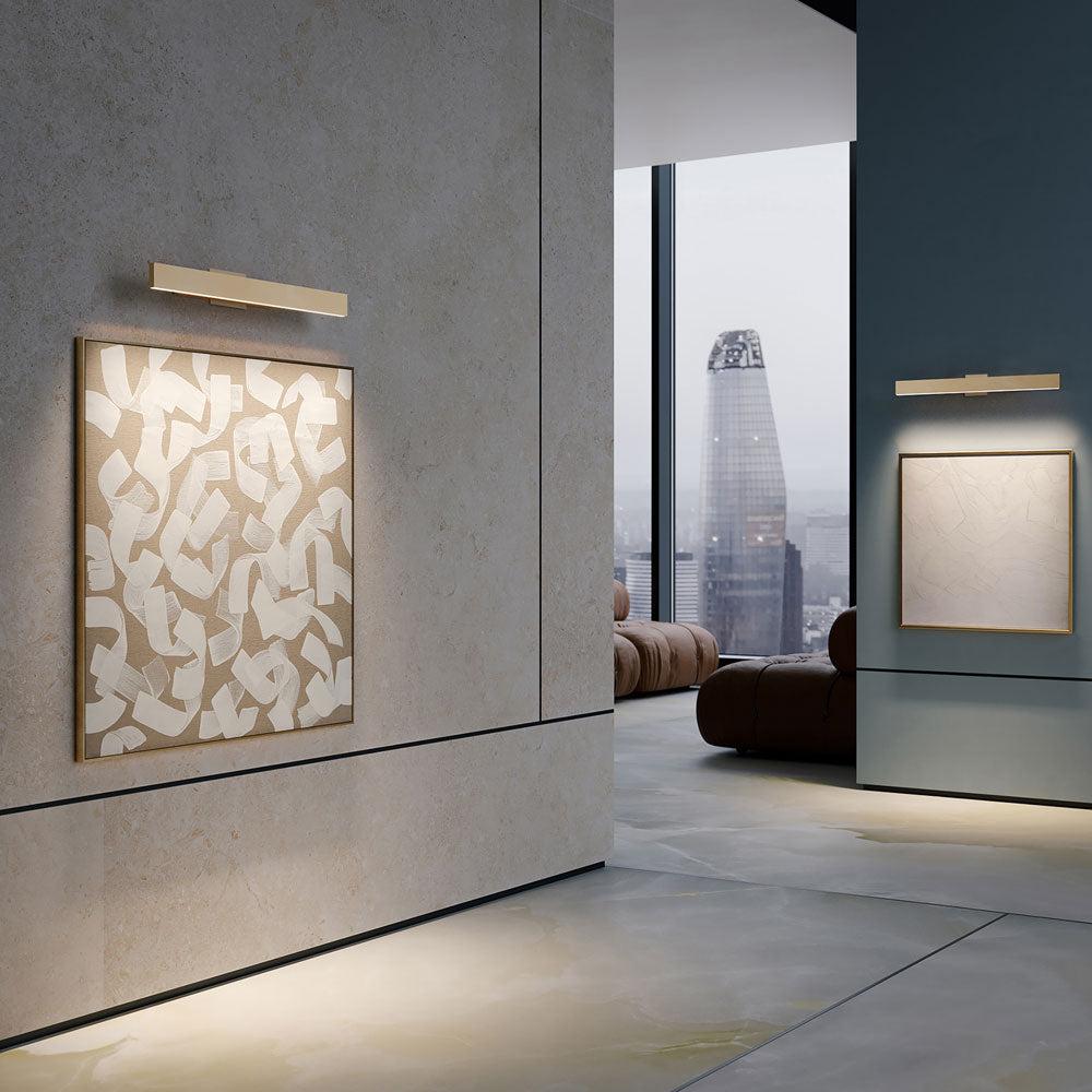 Picture wall lamp illuminating artwork inside a luxury gallery and hospitality interior.