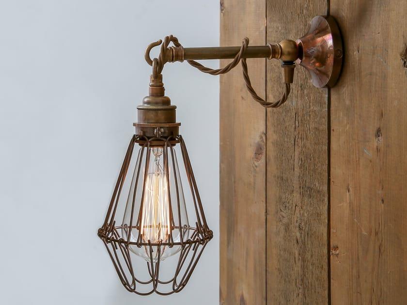 Cage wall lamp installed in a contemporary hospitality interior with industrial architectural styling.