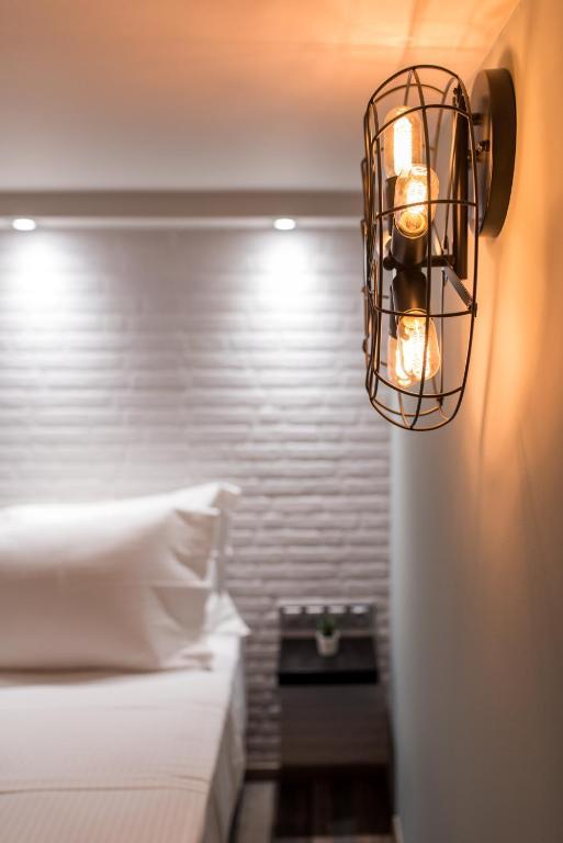Cage wall lamp installed in a contemporary hospitality interior with industrial architectural styling.