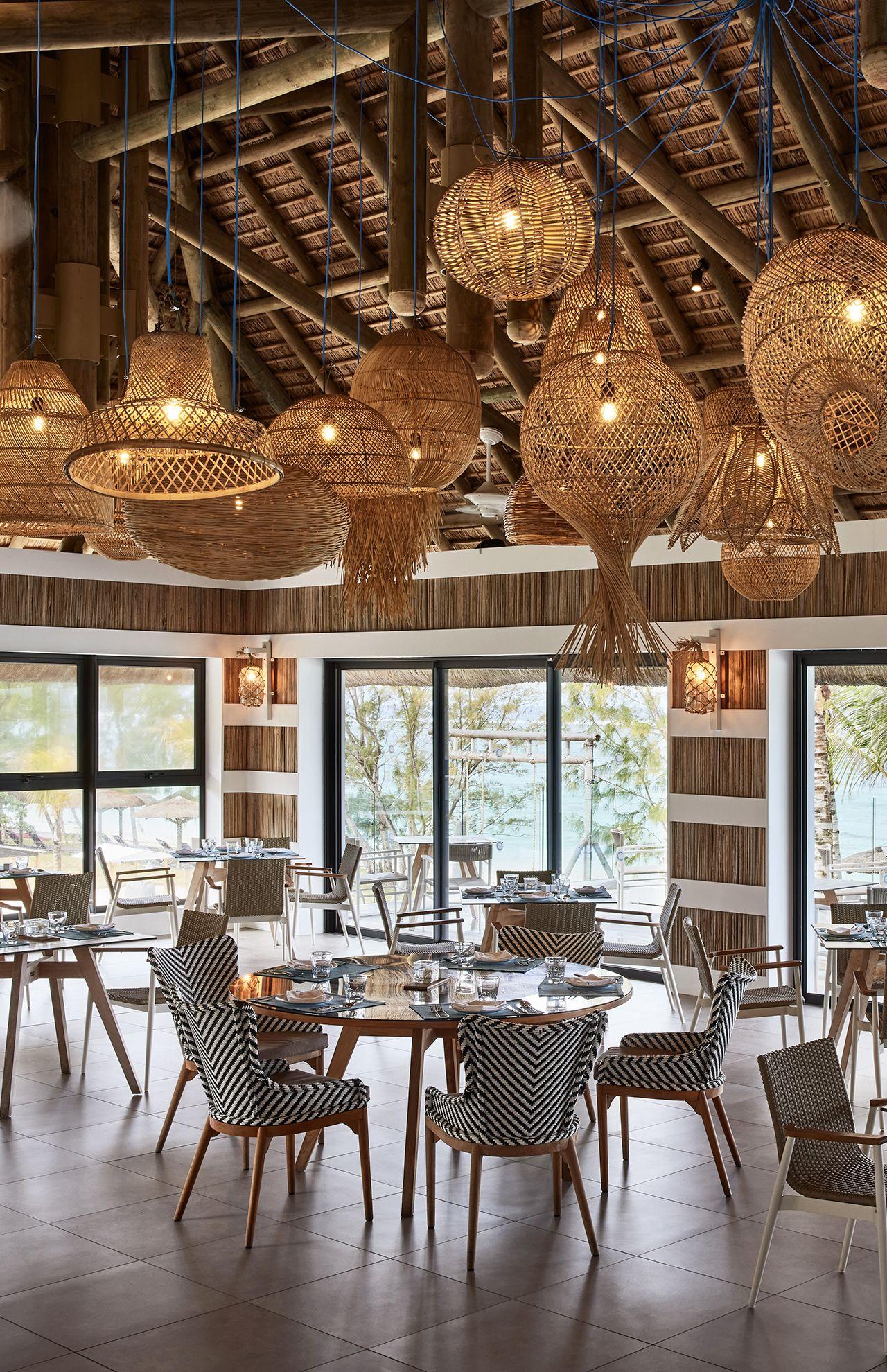 Woven rattan ceiling lights used in a warm boutique hospitality interior