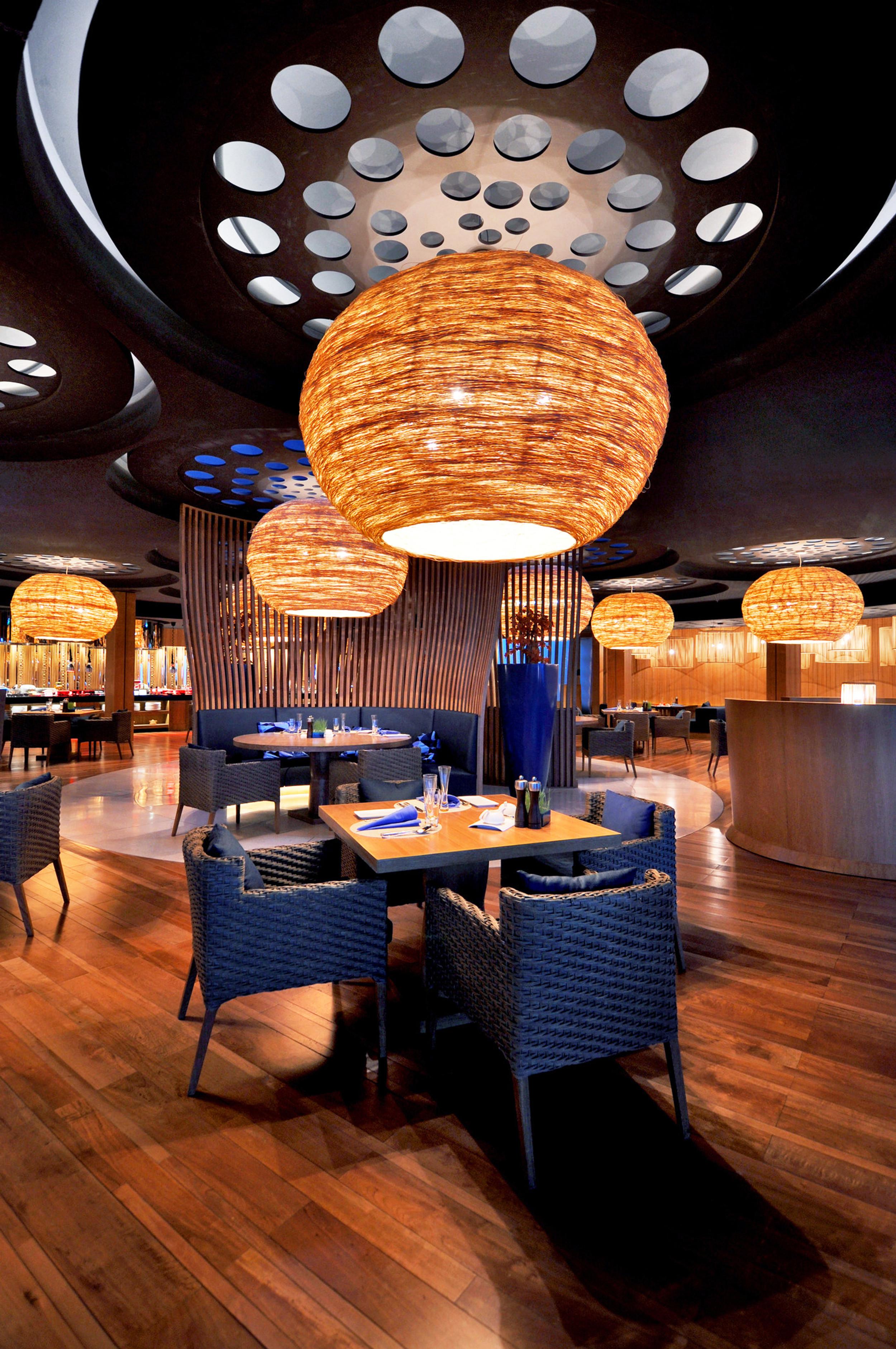 Woven rattan ceiling lights used in a warm boutique hospitality interior