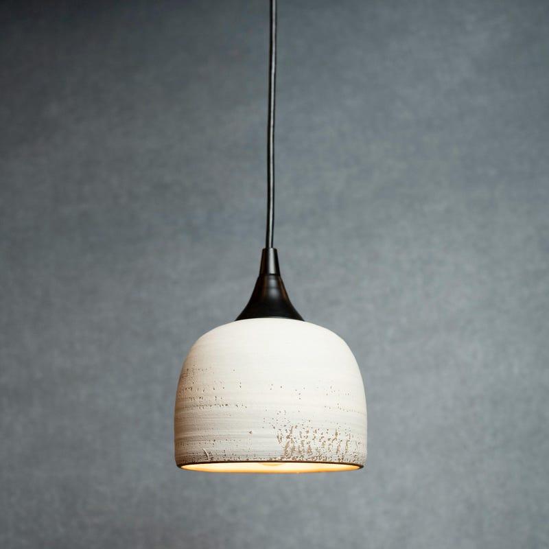 Front view of a decorative ceramic pendant light for residential interiors.