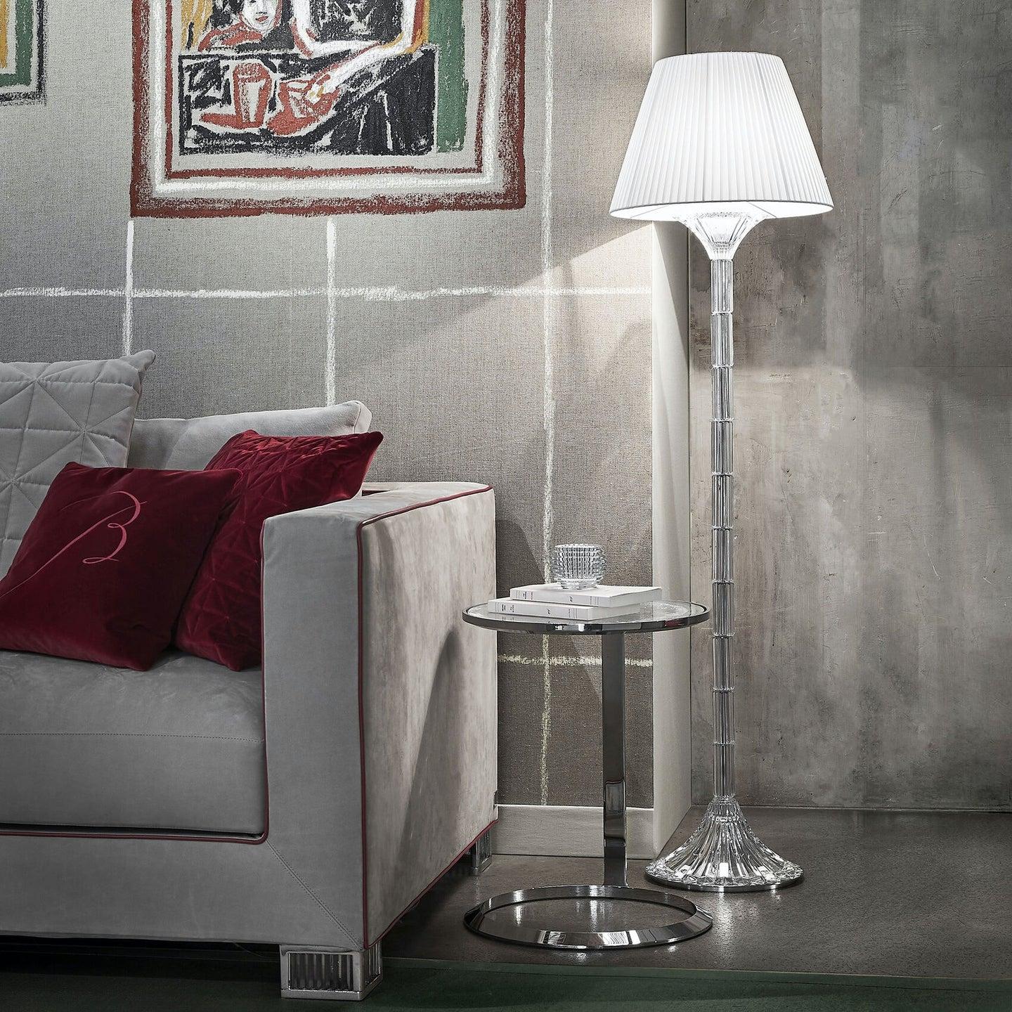 Crystal floor lamp positioned in a luxury hotel lobby creating sparkling reflections and sophisticated ambient lighting.