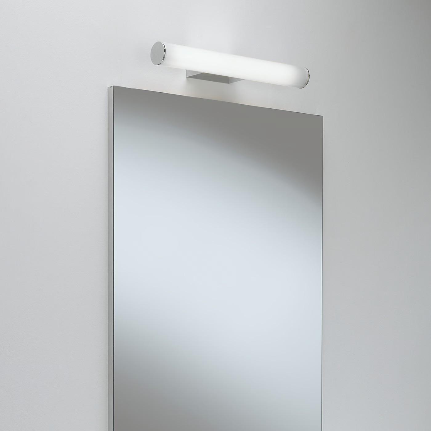 Mirror wall lamp installed beside a luxury hotel bathroom mirror providing balanced illumination.