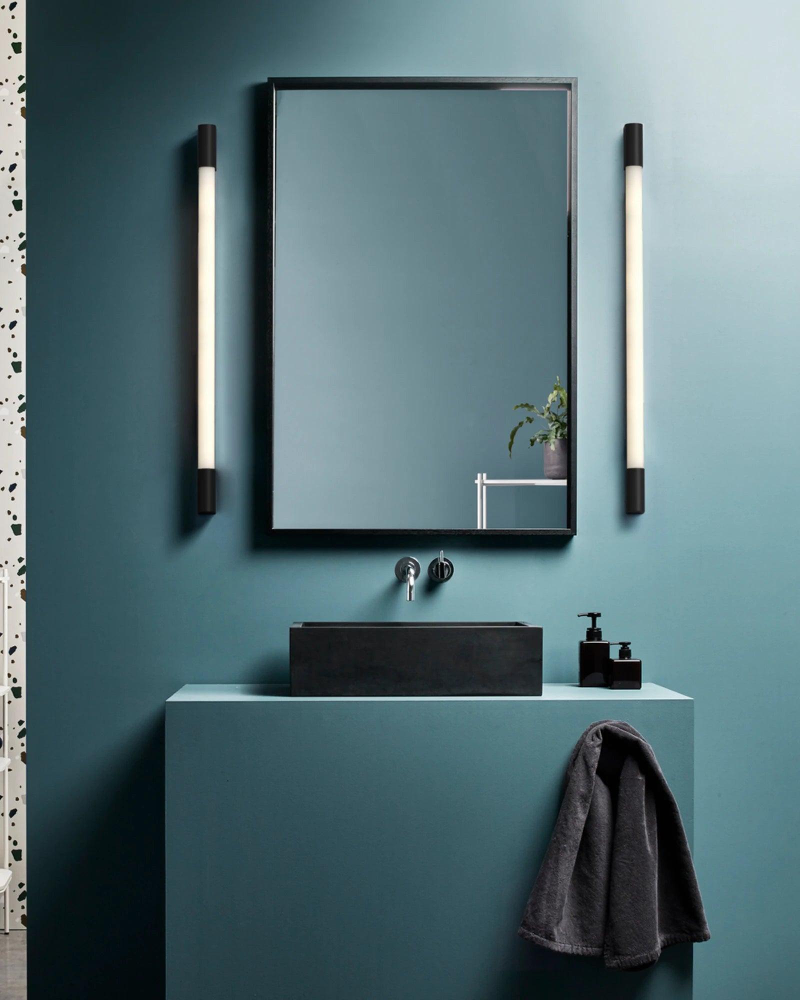 Mirror wall lamp installed beside a luxury hotel bathroom mirror providing balanced illumination.